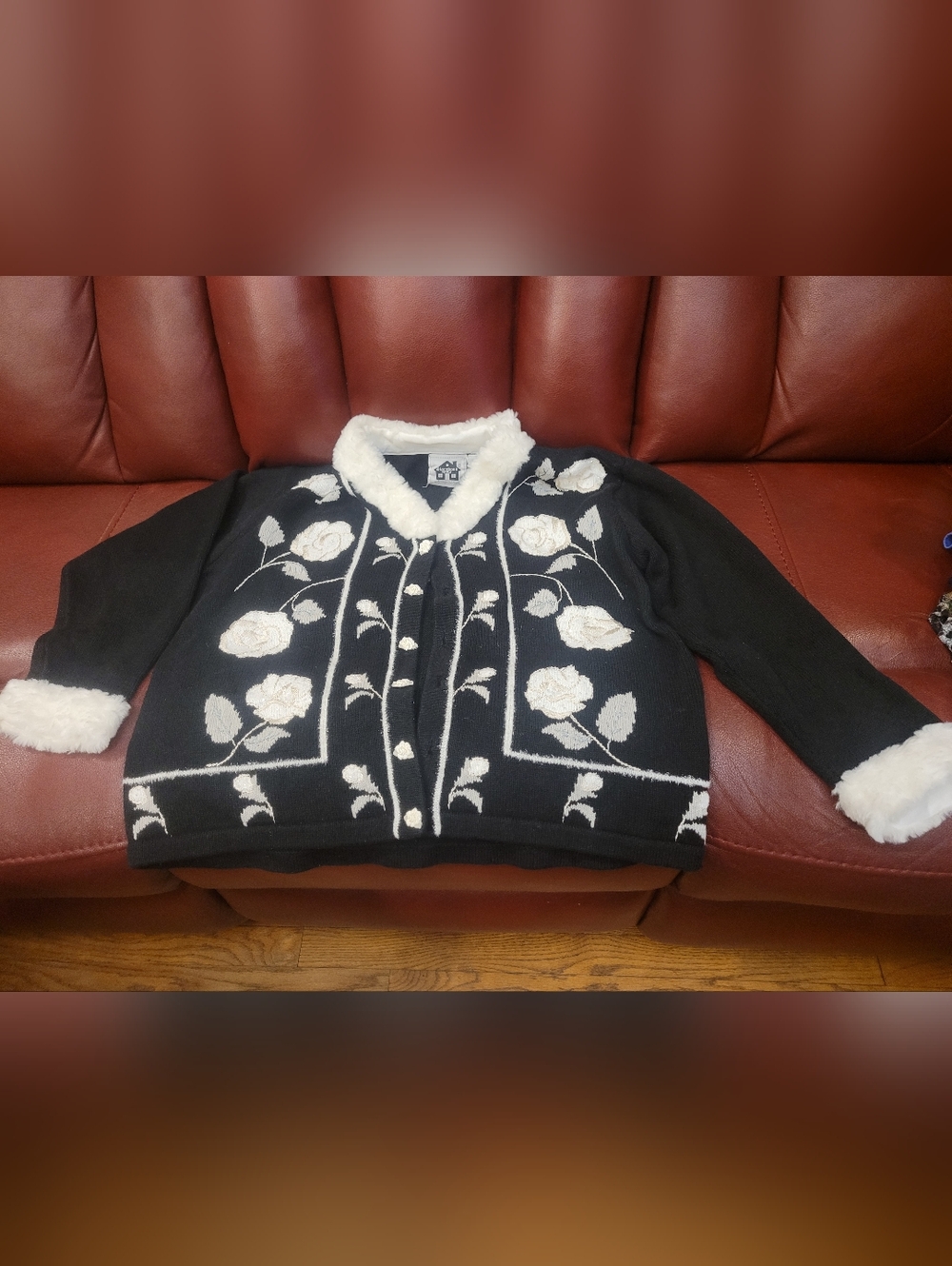 Storybook Knits Black Cardigan with White Rose Embroidery and Faux-Fur Trim